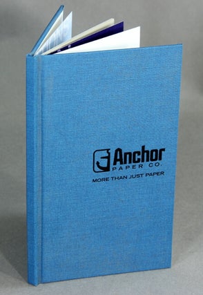 A collection of approximately 65 paper sample books in a custom cardboard Anchor Paper Company bookshelf